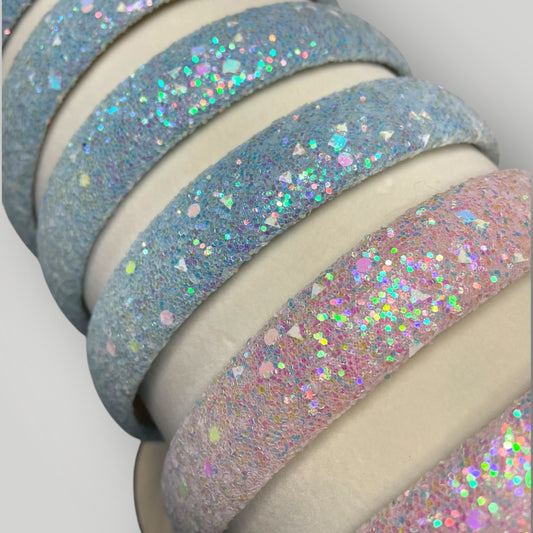 Close- up of blue and pink glittery headbands