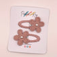 Two dusty pink flower-shaped hair clips with pearl centers, displayed on a white branded card that reads Parker & Kay.